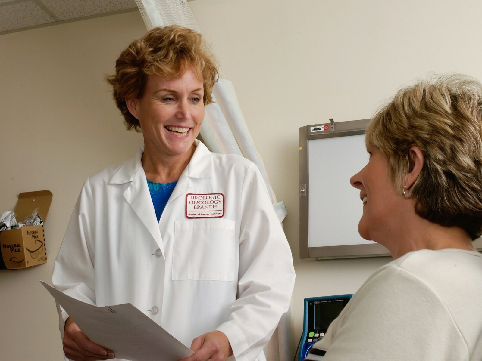 A dentist talking gently with a patient